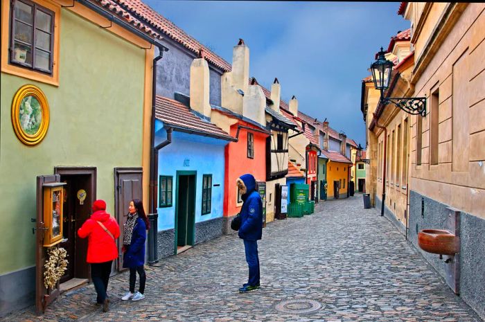 Tourists admiring the historic homes along Golden Lane, Prague Castle, Czech Republic