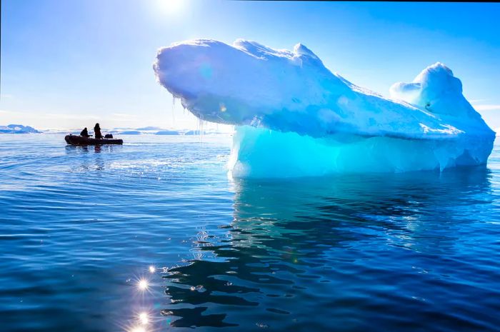 A blue iceberg floats in Nordfjorden, Svalbard