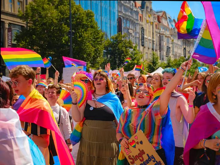 Prague Pride Festival Parade: vibrant and joyful parade-goers adorned with rainbows and various LGBTQ symbols.