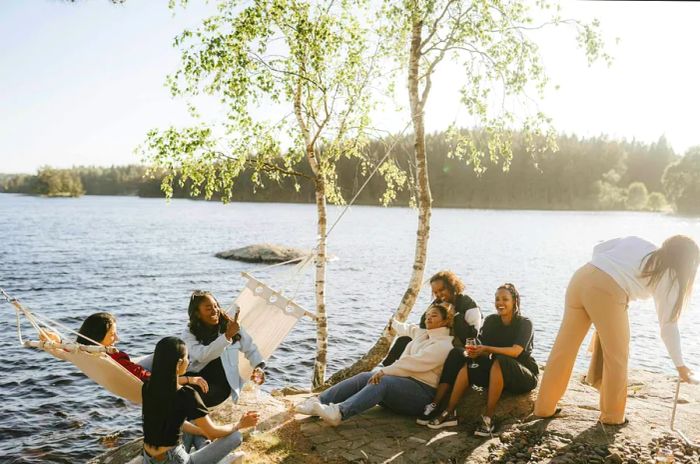 A group of female friends enjoying a sunny day by the lake