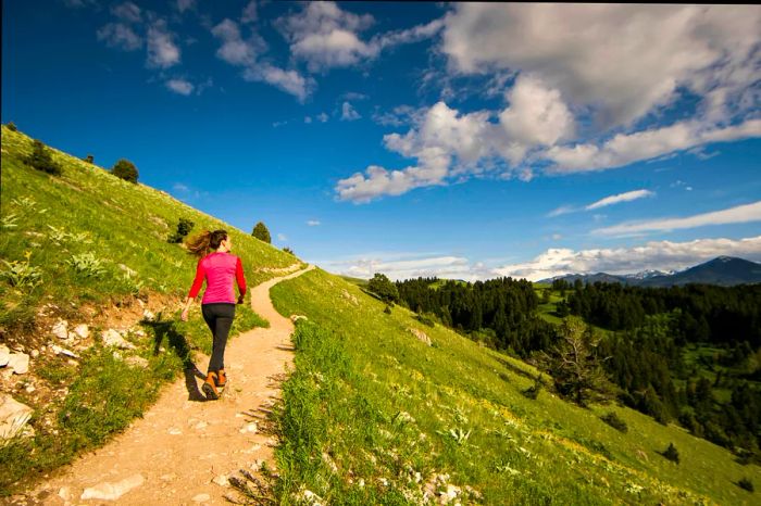 A woman hiking along a hillside trail near Bozeman, Montana