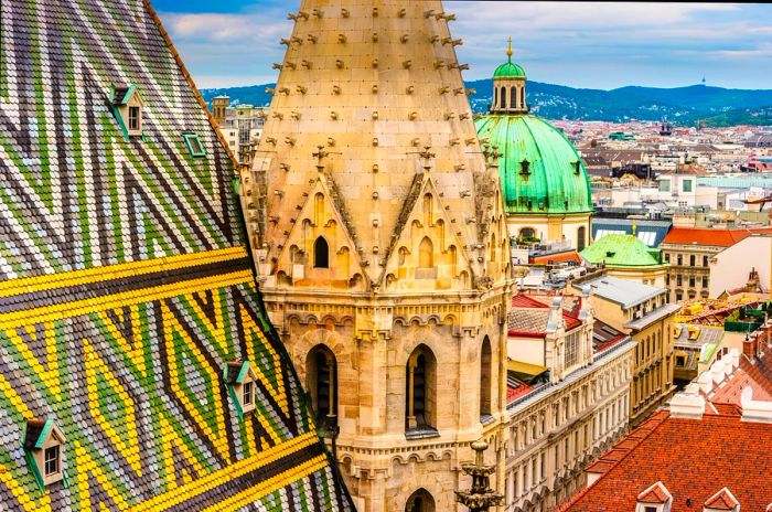 A striking church rooftop adorned with geometric tiles and a Gothic cathedral spire