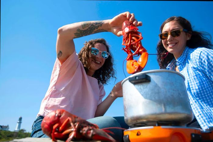 Boiling lobsters near Portland Head Light in Cape Elizabeth, Maine, USA