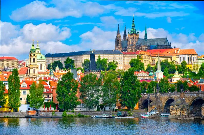 A castle and cathedral tower majestically on a hill overlooking a river