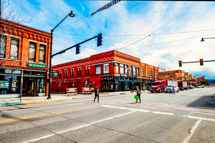 A quaint intersection on Main Street featuring low-rise red-brick shops