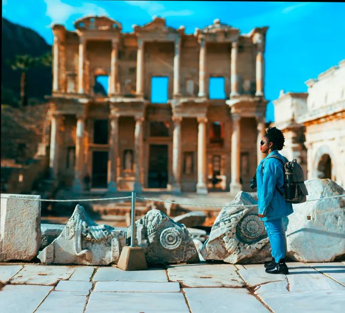 A woman enjoying the ancient ruins of Ephesus on a sunny winter day in İzmir