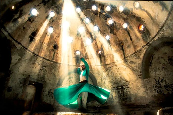 A whirling dervish illuminated by beams of sunlight in Konya