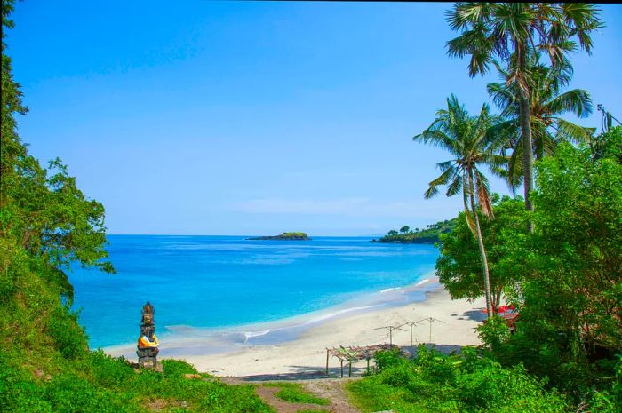 A pathway leading to a secluded sandy beach.