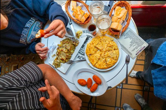 Spanish cuisine is deeply rooted in fresh, seasonal, and often organic ingredients, as seen in these tapas and beer served in Madrid.