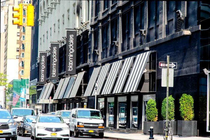 The facade of a large department store featuring Bloomingdale's on its black and white awnings