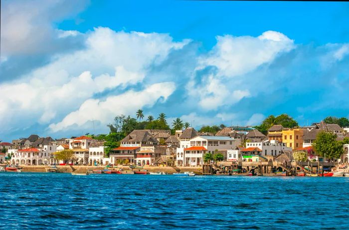 A historic row of buildings lining the edge of a coastal town