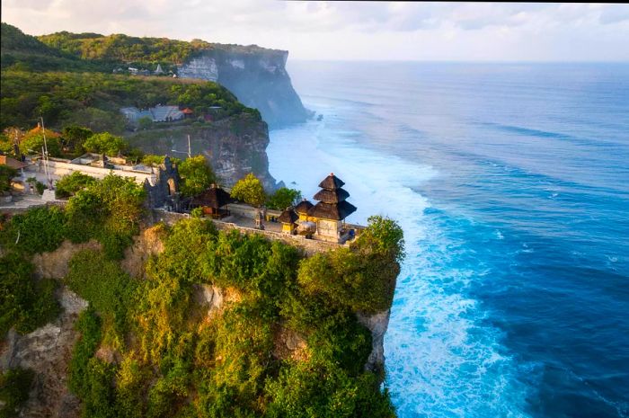 A clifftop temple overlooking the ocean on a bright sunny day.