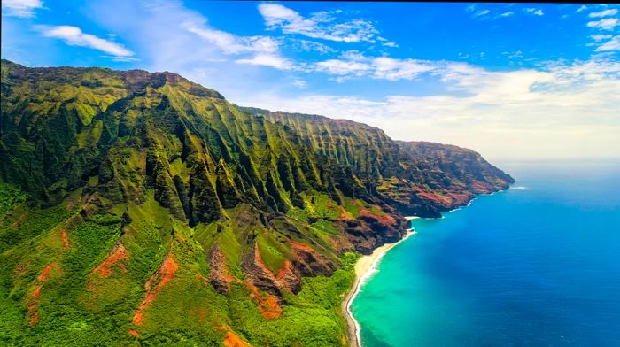 Lush green cliffs tower above the ocean