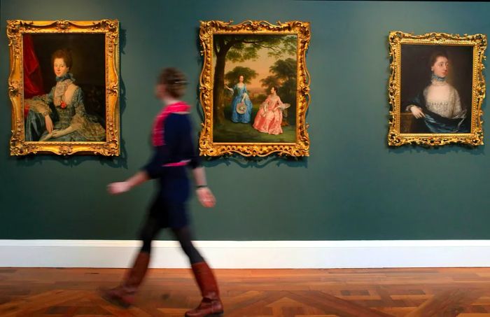 Lisa Hartung, a museum volunteer and aspiring curator, walks past a painting recently displayed at the preview of the new Holburne Museum, ahead of its reopening on May 12, 2011, in Bath, England.