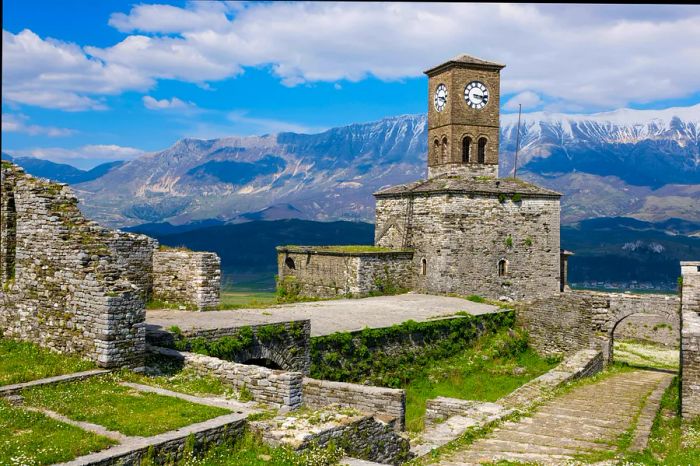 A historic stone fortress with a prominent clock tower