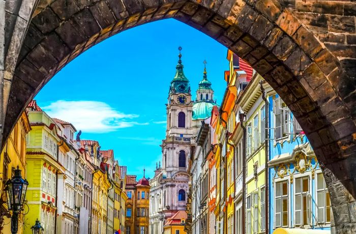 View of pastel-hued historic buildings framed by an archway