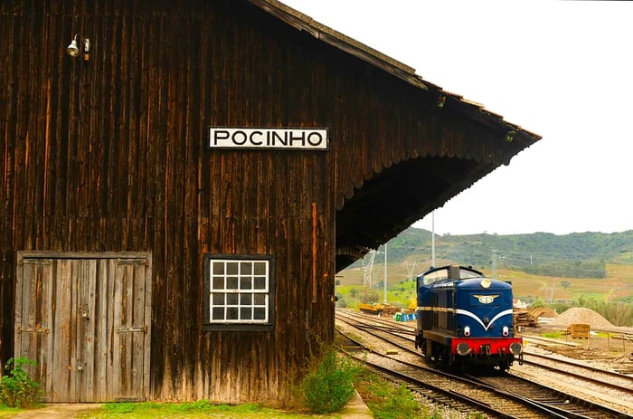 A wooden station building next to a train engine