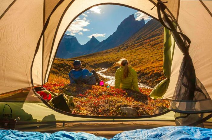 Visitors relax outside their tent in Gates of the Arctic National Park.