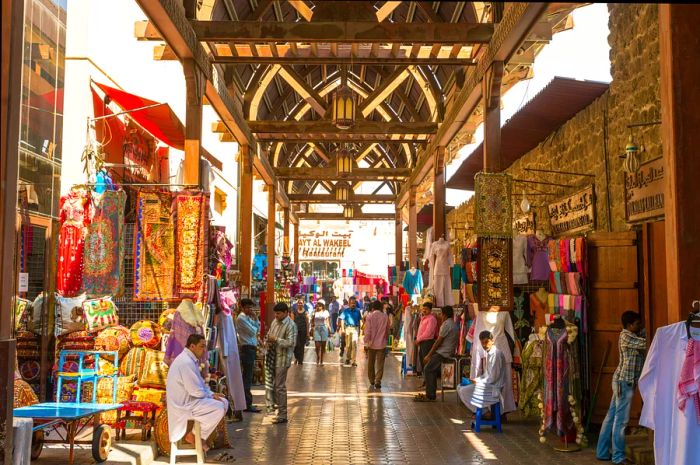 Busy textile souk bustling with shoppers during the day in Bur Dubai, Dubai, United Arab Emirates