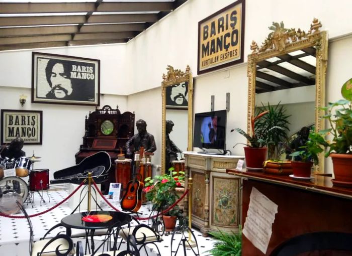 Inside the museum dedicated to Turkish rock legend Barış Manço, instruments are displayed alongside promotional posters that adorn the walls.