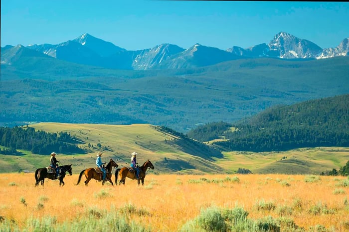 A trio enjoying an autumn horseback ride at the Ranch at Rock Creek