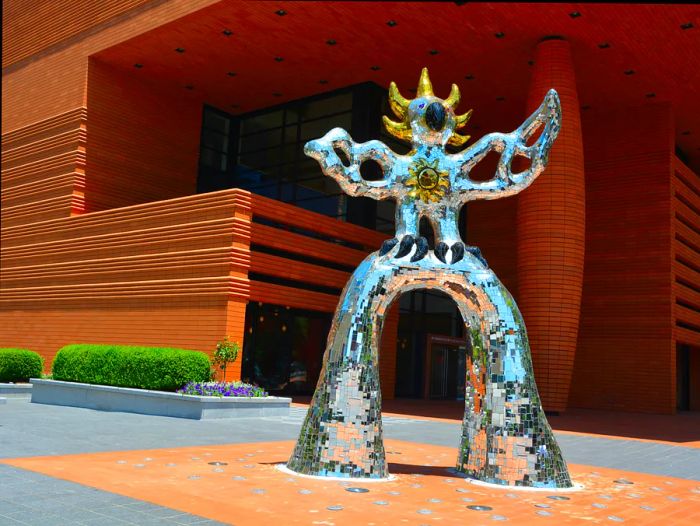 A shimmering silver and gold sculpture located outside the Bechtler Museum in North Carolina.