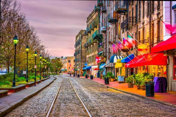 Streetcar tracks, eateries, and bars along River Street in Savannah