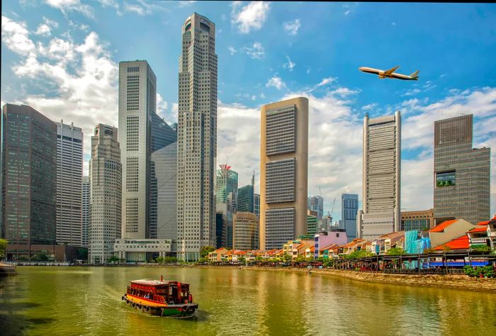 An airplane ascends above a cityscape by the quay