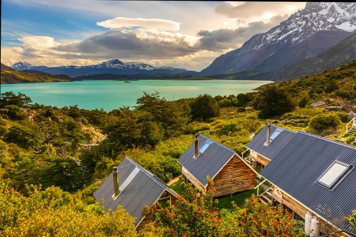 Lakeside wooden cabins set in a mountainous landscape