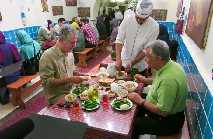 Anthony Bourdain sharing a meal with a friend in Iran.