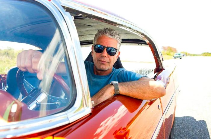 Anthony Bourdain cruising in a classic car through Havana.