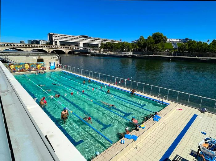 Swimmers relish the open-air floating Josephine Baker Pool located in the 13th arrondissement of Paris, France.