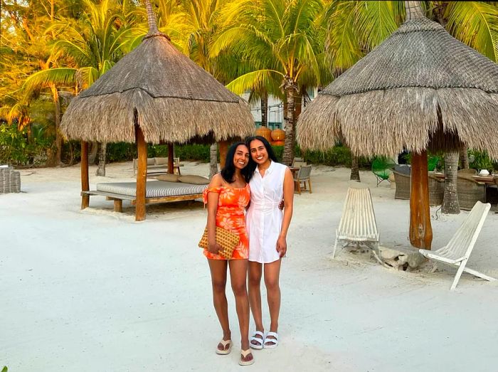 Serina and her sister take a moment on the beach in Isla Holbox