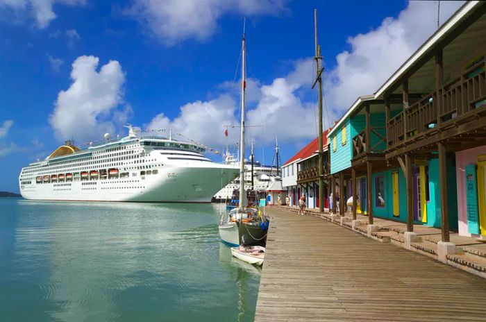 A cruise ship docked at a pier surrounded by vibrant wooden structures.