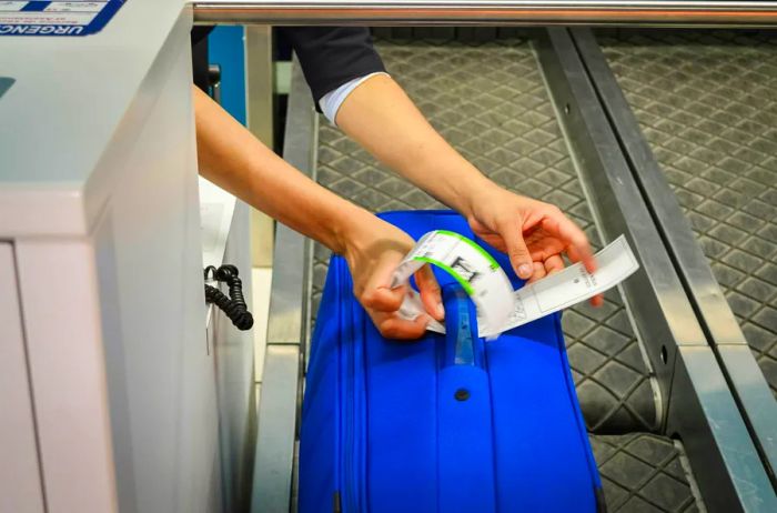 Image of colorful luggage being checked in at the airport