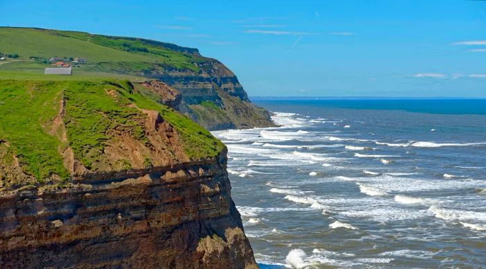 Massive waves crash against coastal cliffs