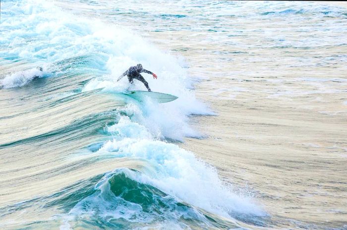 A surfer expertly navigating a wave