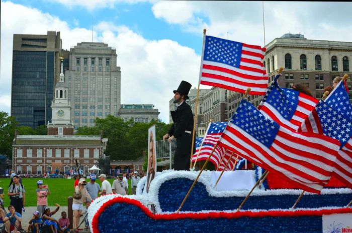 Abraham Lincoln rides a float in the Independence Day Parade along Market St in Philadelphia.