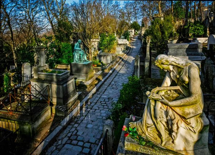 A white marble angel statue graces the tomb of composer Frédéric Chopin at Père-Lachaise Cemetery in Paris