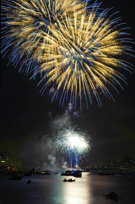 Witness the Fourth of July Fireworks 2012 in Boston illuminating the Charles River, with kayaks and boats dotting the water.