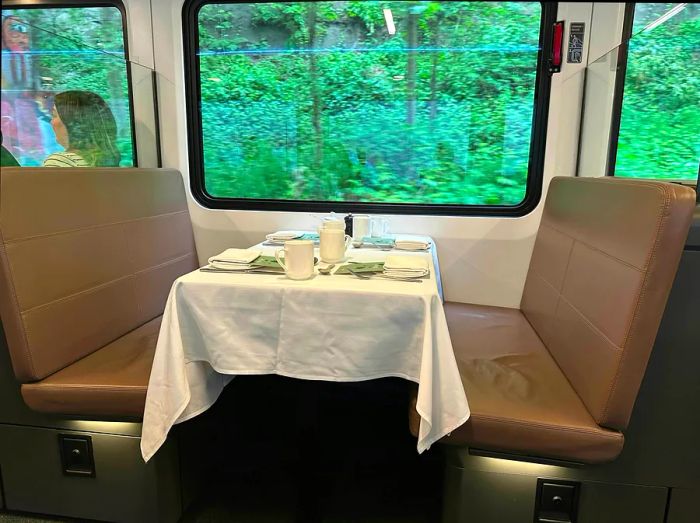 A dining car table featuring cozy leather-covered benches