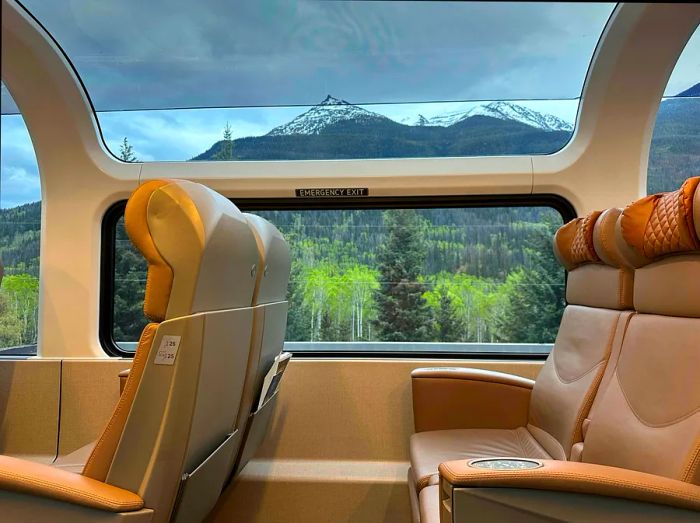 A mountain seen from inside a carriage on a scenic train journey