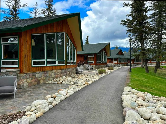 Charming wooden cabins with expansive windows lining a path