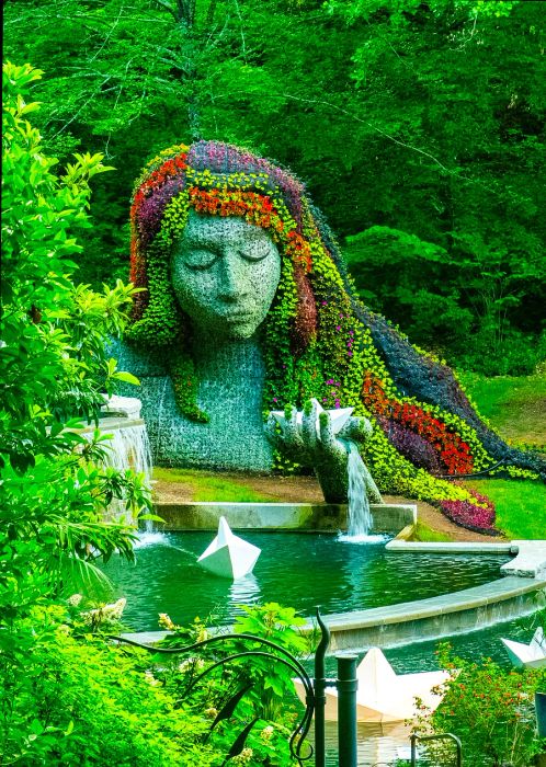 A stunning water feature and floral arrangement shaped like a woman’s head and shoulders at Atlanta Botanical Garden