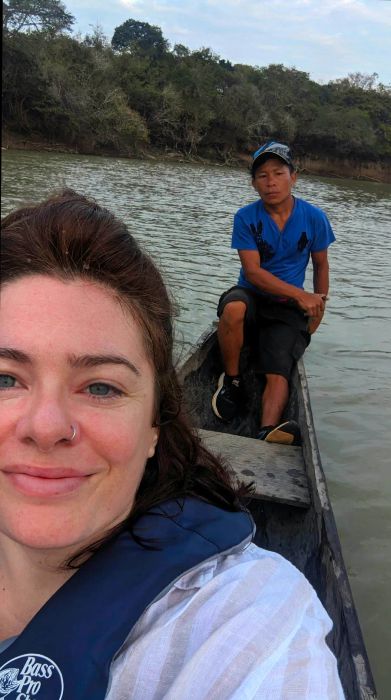 A traveler enjoying a guided boat tour in Guyana, both smiling for the camera