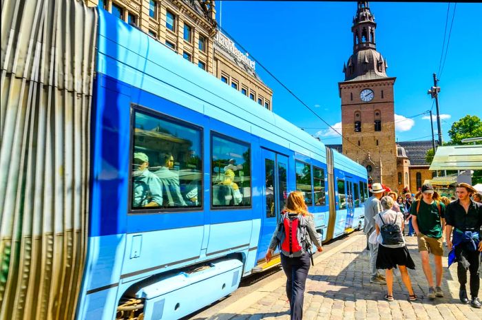 A woman hurrying to catch a tram in Oslo, Norway's capital.