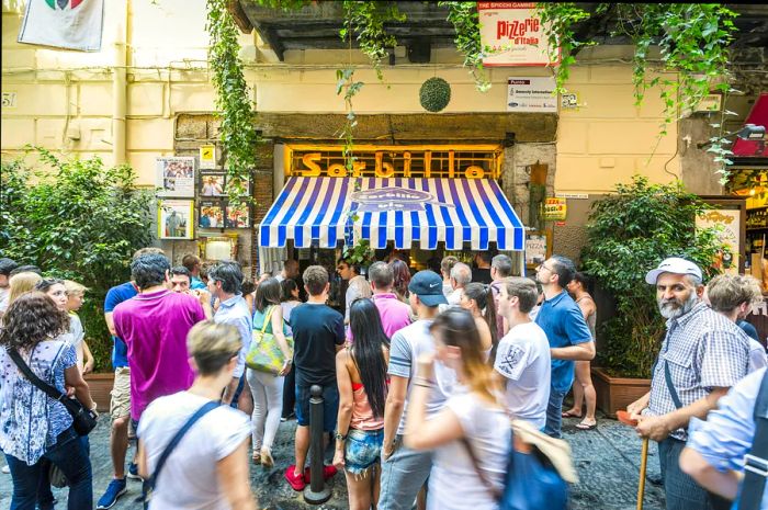 A long line awaits at Gino Sorbillo Pizzeria, the birthplace of pizza.