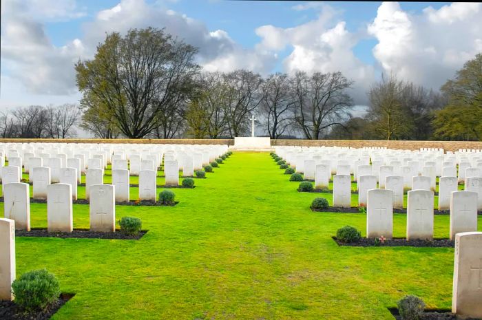 A row of white headstones in a military cemetery