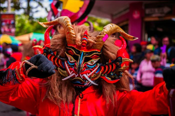 Person wearing a red devil mask at the Diablada or Devil Festival