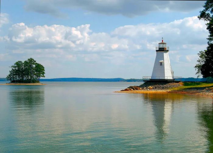 A quaint lighthouse nestled beside a lush lake.